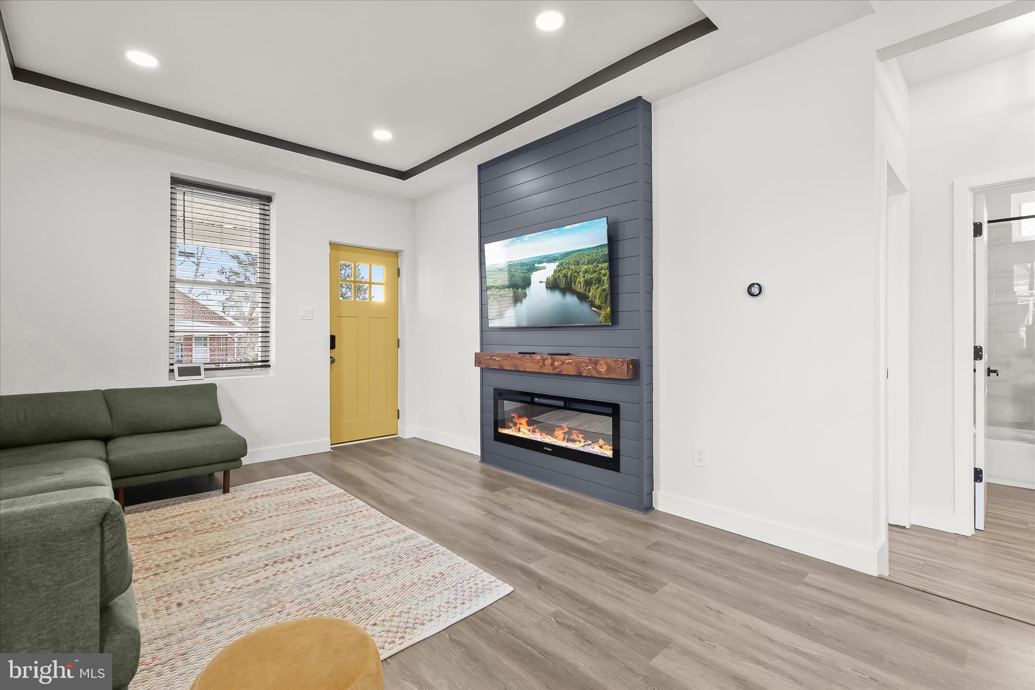 5822 Ethelbert Avenue Baltimore, MD 21215 - Photo 6 of 37 a living room with furniture and a fireplace
