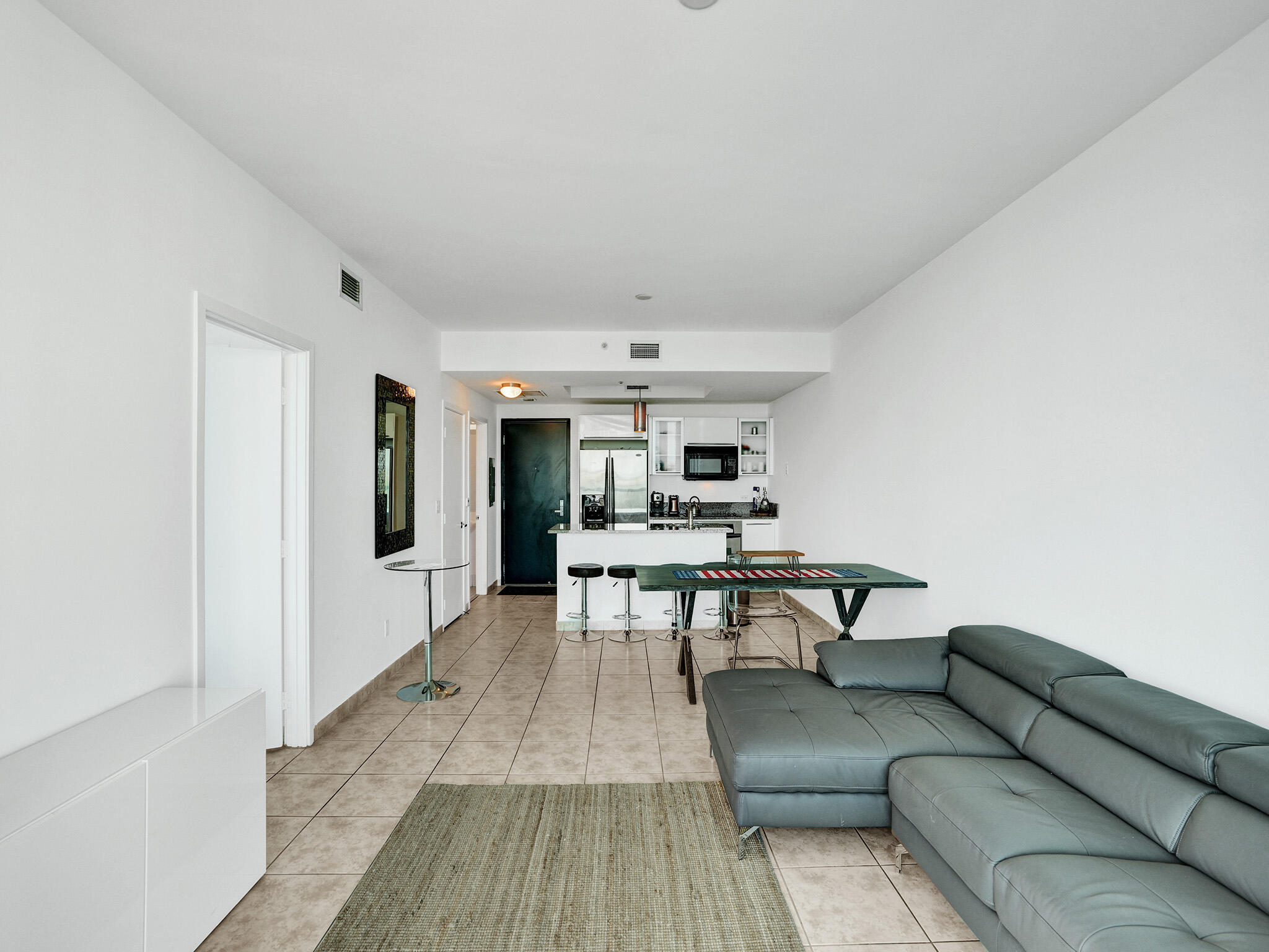 888 Biscayne Boulevard, Unit 811 Miami, FL 33132 - Photo 11 of 48 a living room with furniture and a dining table with kitchen view