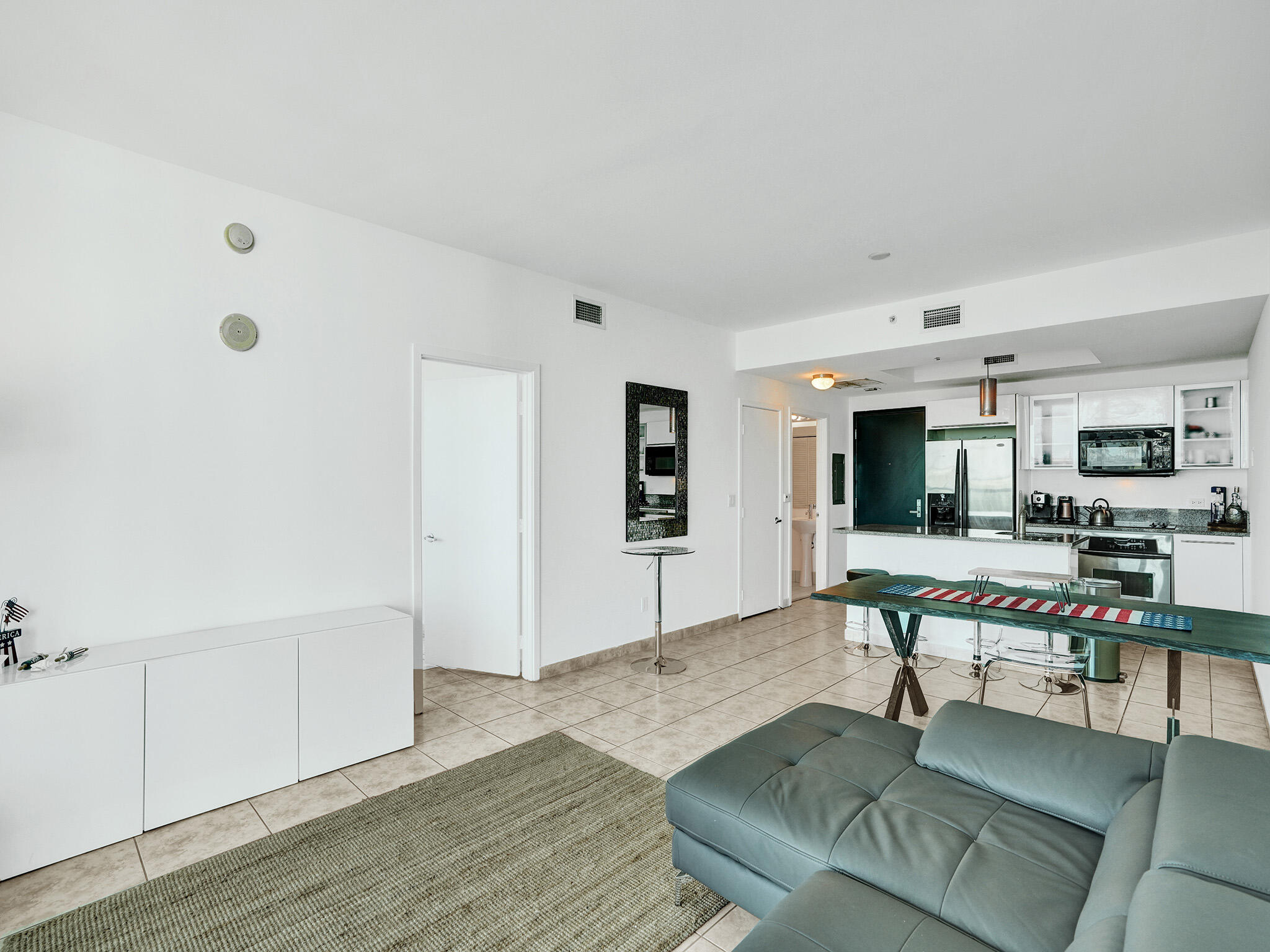 888 Biscayne Boulevard, Unit 811 Miami, FL 33132 - Photo 12 of 48 a living room with furniture and a wooden floor