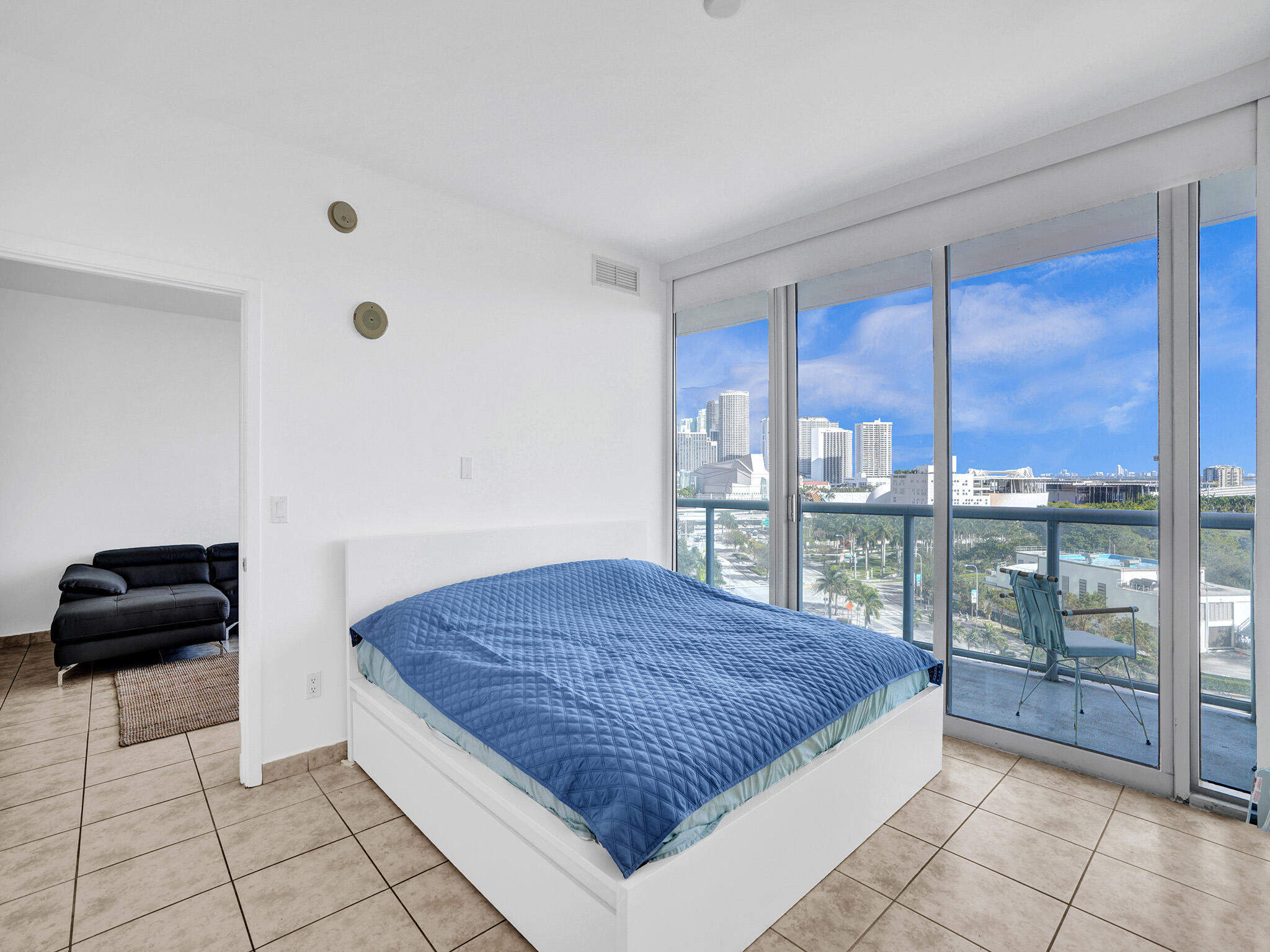 888 Biscayne Boulevard, Unit 811 Miami, FL 33132 - Photo 13 of 48 a bedroom with a bed and glass window