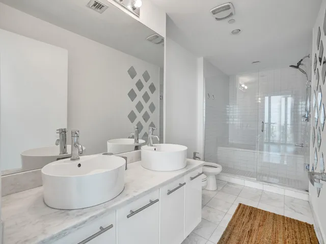 a bathroom with a sink double vanity and a mirror