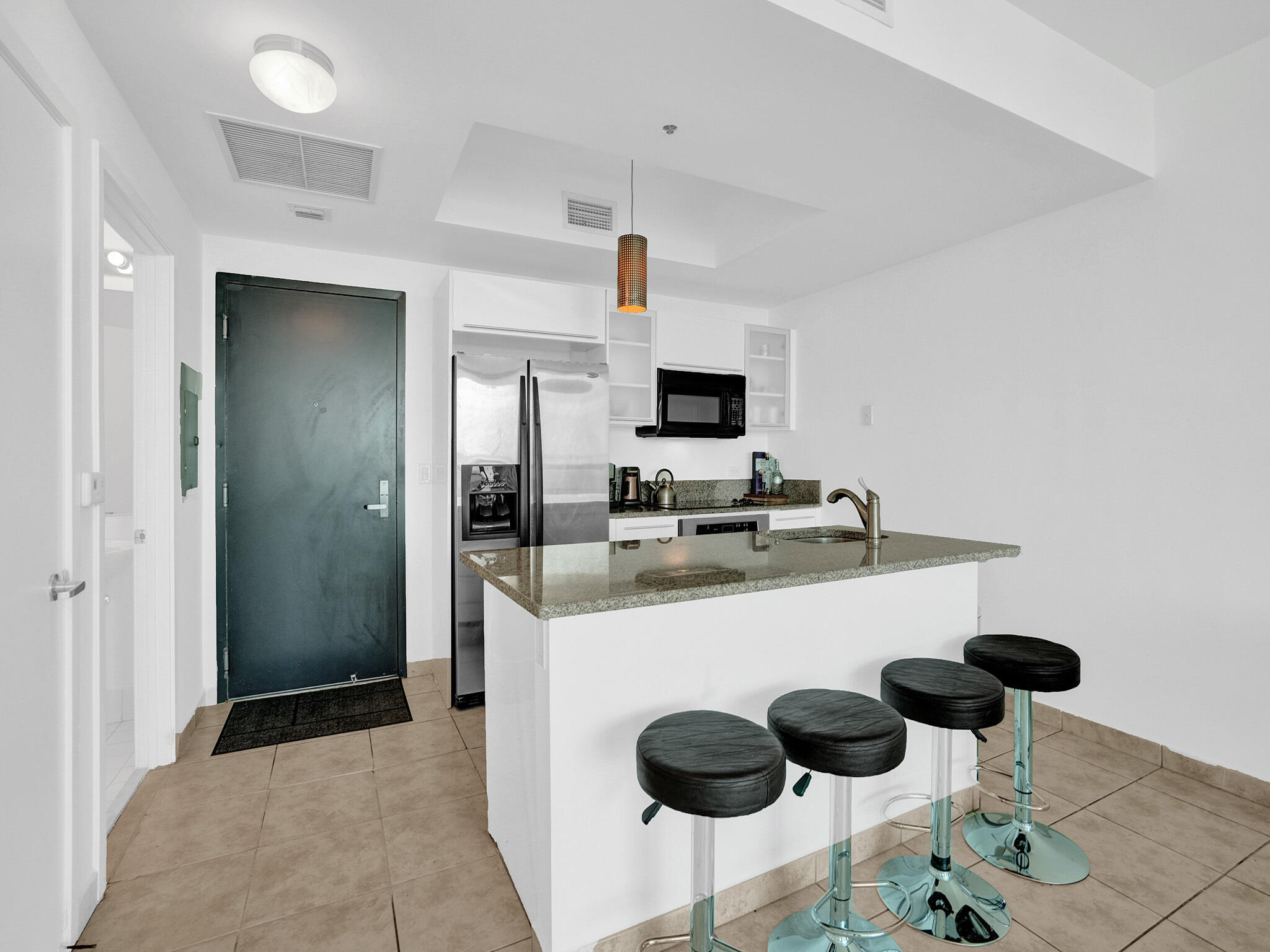 888 Biscayne Boulevard, Unit 811 Miami, FL 33132 - Photo 2 of 48 a kitchen with stainless steel appliances granite countertop a sink and a refrigerator