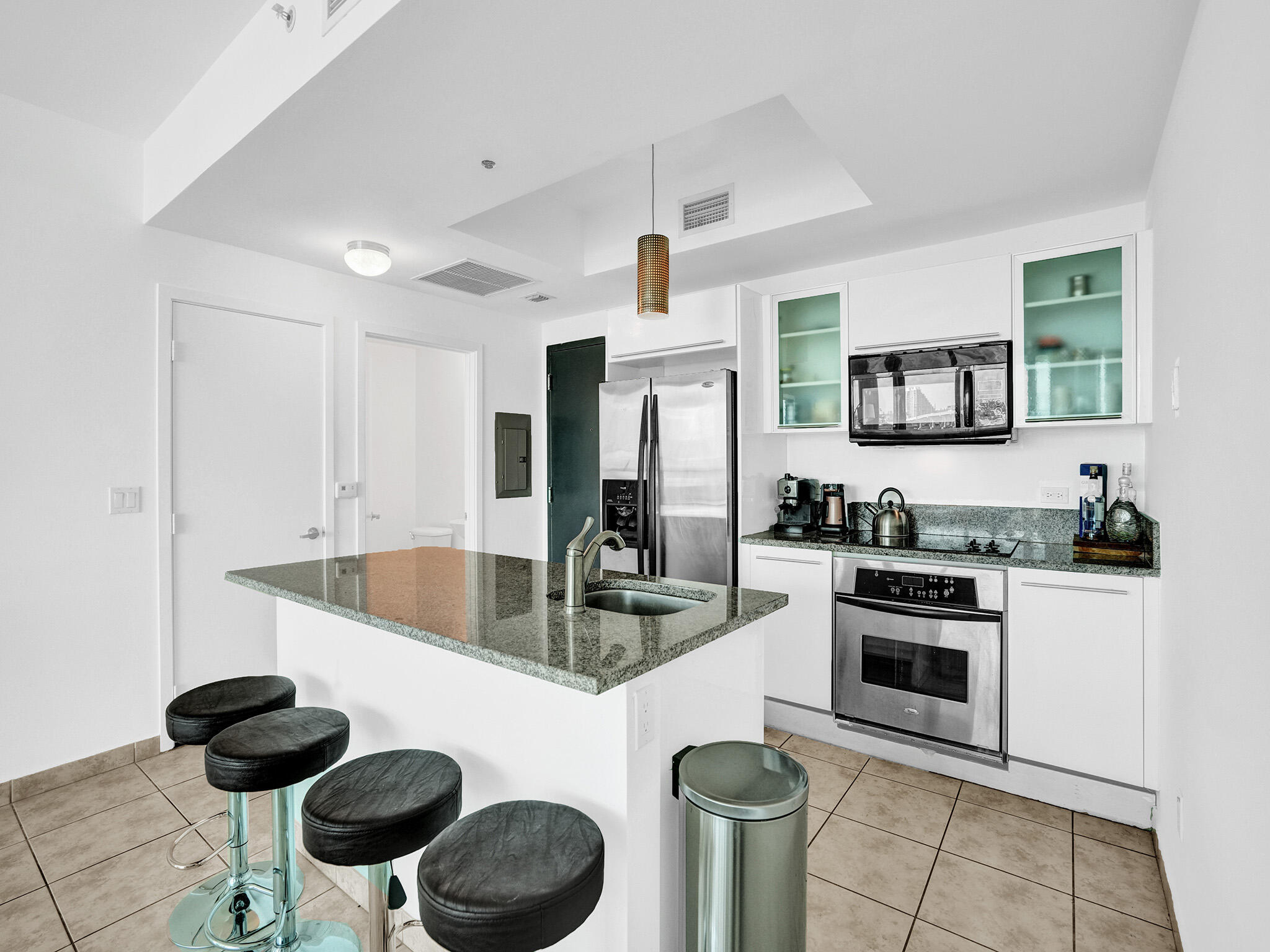 888 Biscayne Boulevard, Unit 811 Miami, FL 33132 - Photo 3 of 48 a kitchen with stainless steel appliances granite countertop a sink and a stove