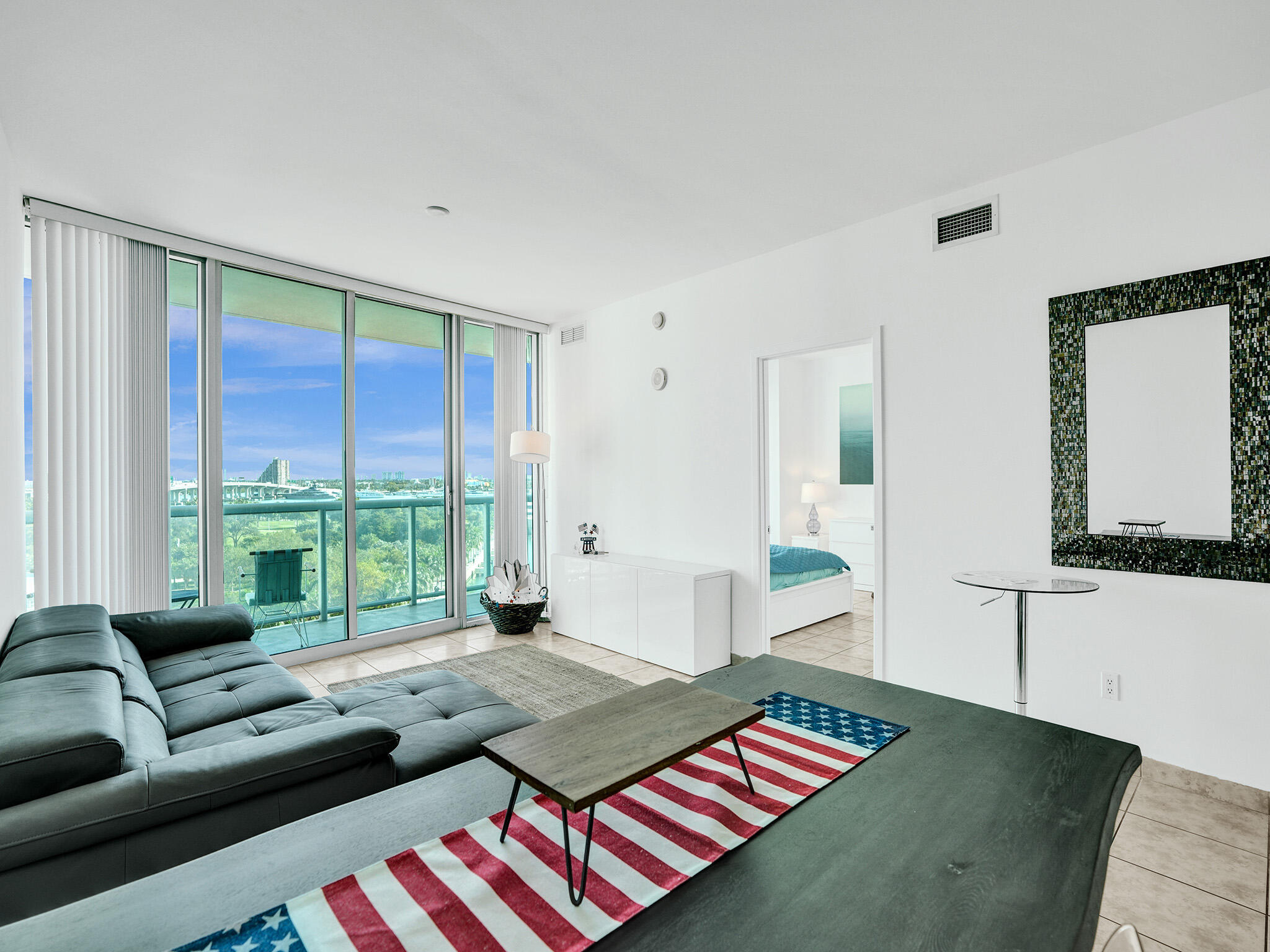 888 Biscayne Boulevard, Unit 811 Miami, FL 33132 - Photo 8 of 48 a living room with furniture and a floor to ceiling window