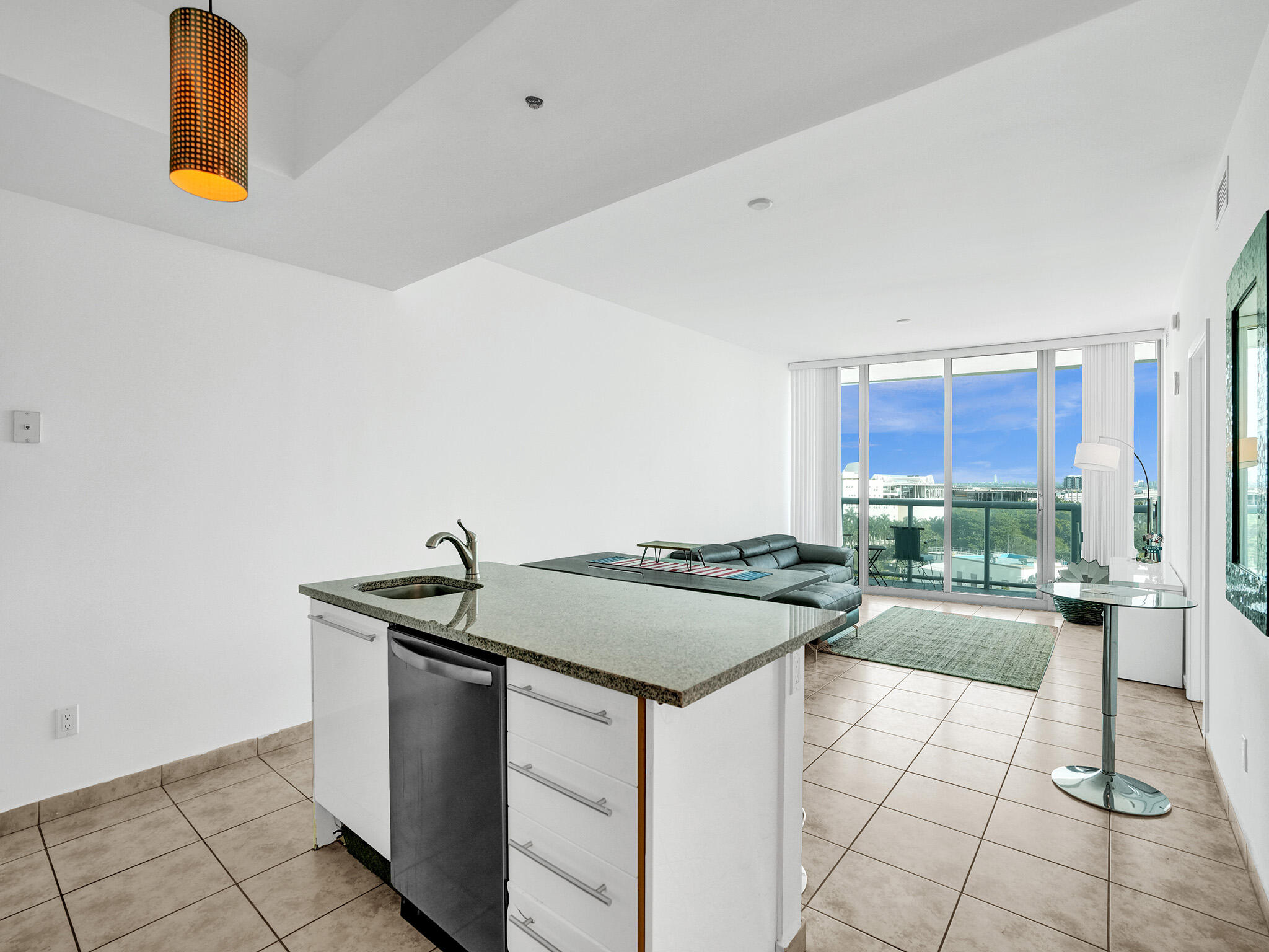 888 Biscayne Boulevard, Unit 811 Miami, FL 33132 - Photo 10 of 48 a kitchen with a sink and cabinets