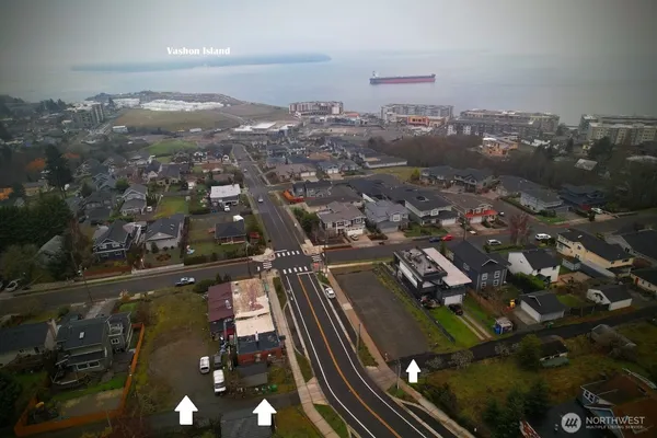 an aerial view of residential houses with city view