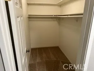 a view of closet with wooden floor