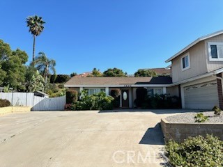 1320 Cadwell Court Riverside, CA 92506 - Photo 3 of 44 a front view of a house with a garden
