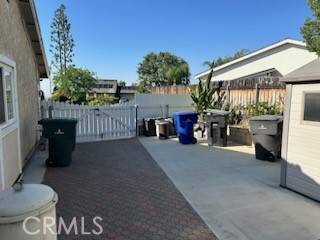 1320 Cadwell Court Riverside, CA 92506 - Photo 37 of 44 a view of a patio with table and chairs potted plants with wooden fence