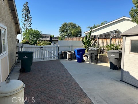 1320 Cadwell Court Riverside, CA 92506 - Photo 43 of 44 a view of a patio with table and chairs potted plants with wooden fence