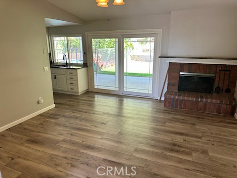 1320 Cadwell Court Riverside, CA 92506 - Photo 8 of 44 a view of empty room with wooden floor and fireplace