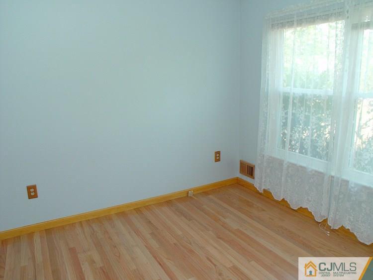 21 Smithwold Road Somerset, NJ 08873 - Photo 8 of 20 a view of empty room with wooden floor and fan