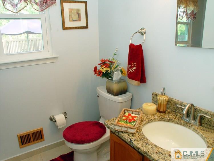 21 Smithwold Road Somerset, NJ 08873 - Photo 9 of 20 a bathroom with a toilet sink and mirror