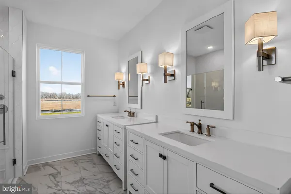 a bathroom with a glass shower door and a window