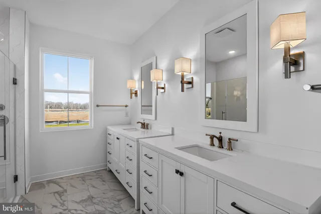 a bathroom with a glass shower door and a window