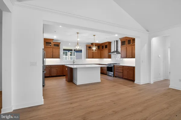 a large white kitchen with a large island in the center