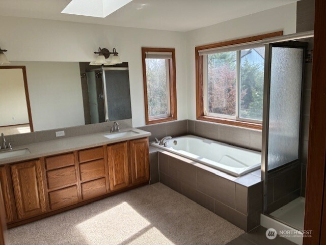 12312 9th Street East Edgewood, WA 98372 - Photo 12 of 20 a bathroom with a tub sink and mirror