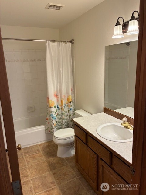 12312 9th Street East Edgewood, WA 98372 - Photo 14 of 20 a bathroom with a sink a toilet and shower