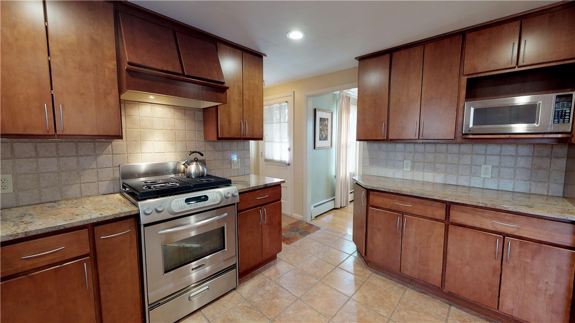 70 Timberline Road Warwick, RI 02886 - Photo 7 of 32 Kitchen updates include solid wood cabinetry with pull out shelving, beautiful granite countertops, undercabinet lighting, matching stainless steel appliances.