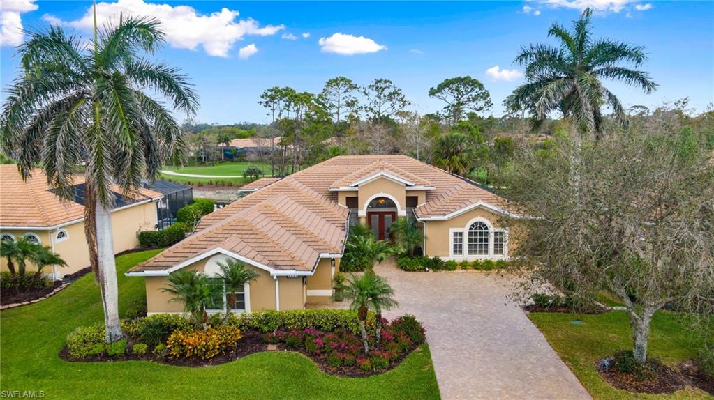 3832 Wax Myrtle Run Naples, FL 34112 - Photo 1 of 44 a front view of a house with a yard and potted plants