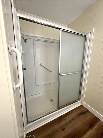 a bathroom with a glass shower door