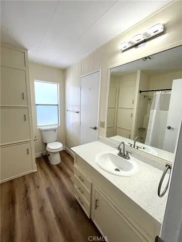 a bathroom with a sink toilet and mirror