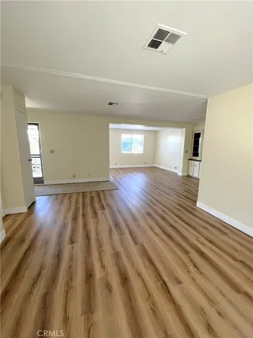 a view of an empty room and wooden floor