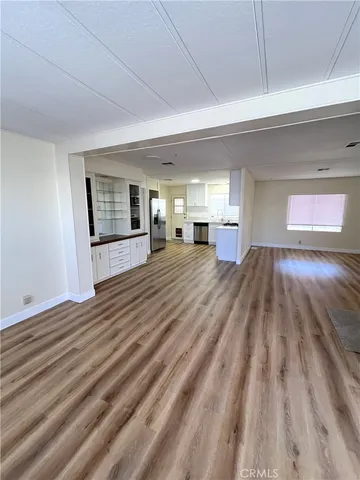 a view of a room with wooden floor and window
