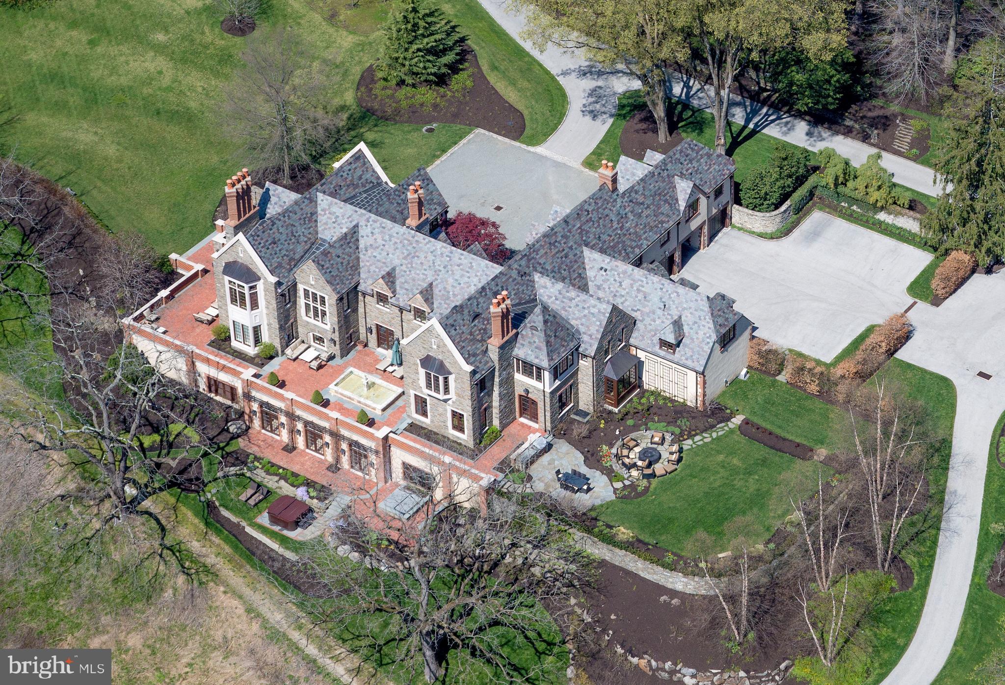 an aerial view of a house with a garden and trees