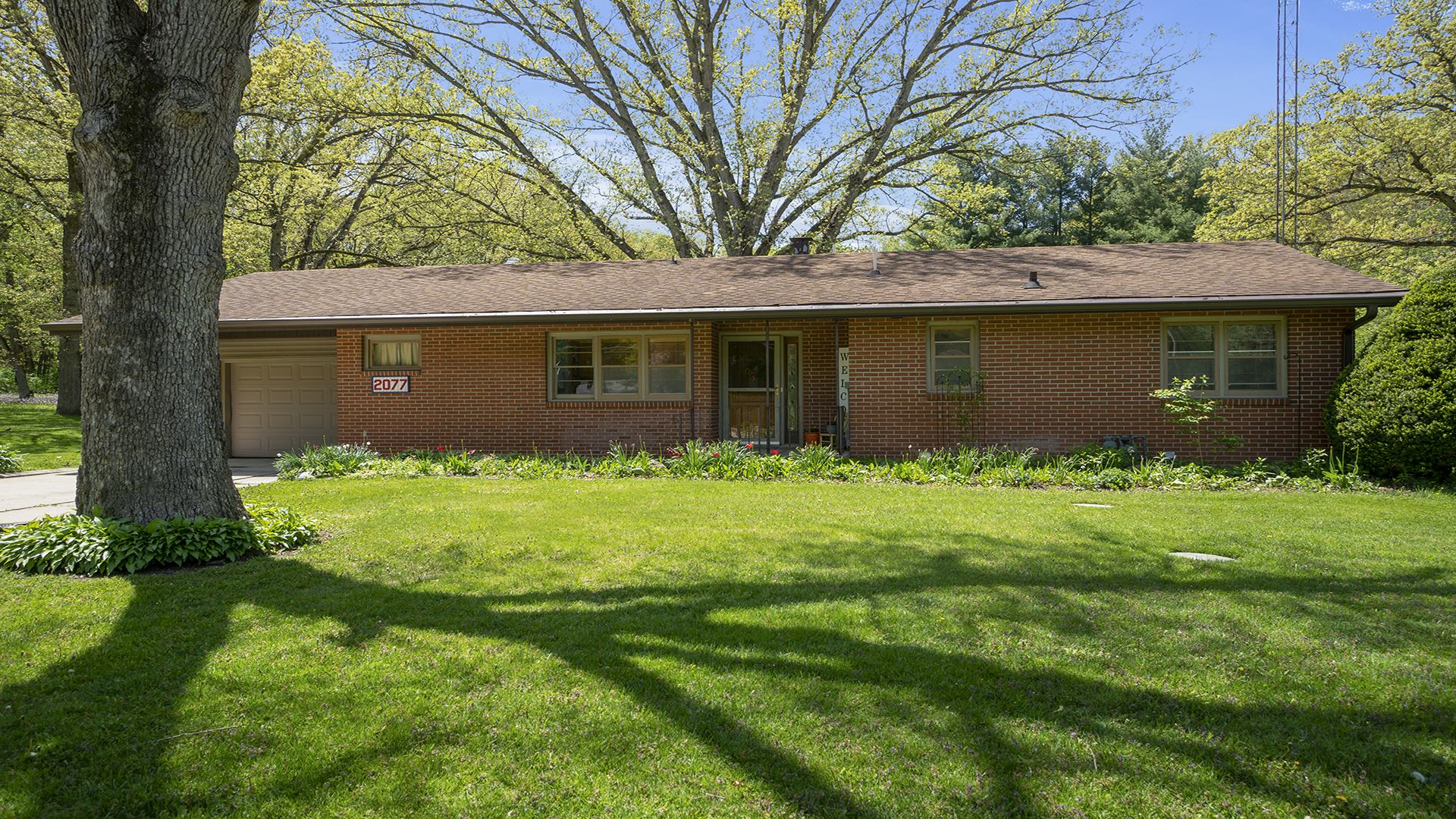2077 Grand Detour Road Dixon, IL 61021 - Photo 1 of 33 a front view of a house with a garden