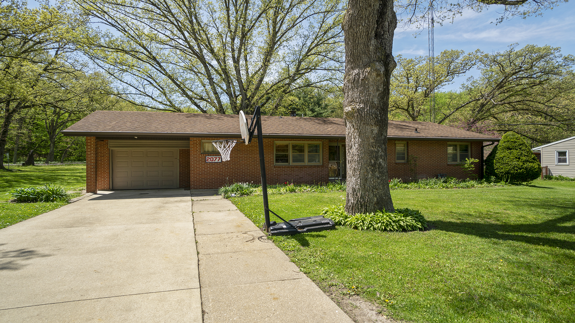 2077 Grand Detour Road Dixon, IL 61021 - Photo 2 of 33 a front view of a house with a yard and garage
