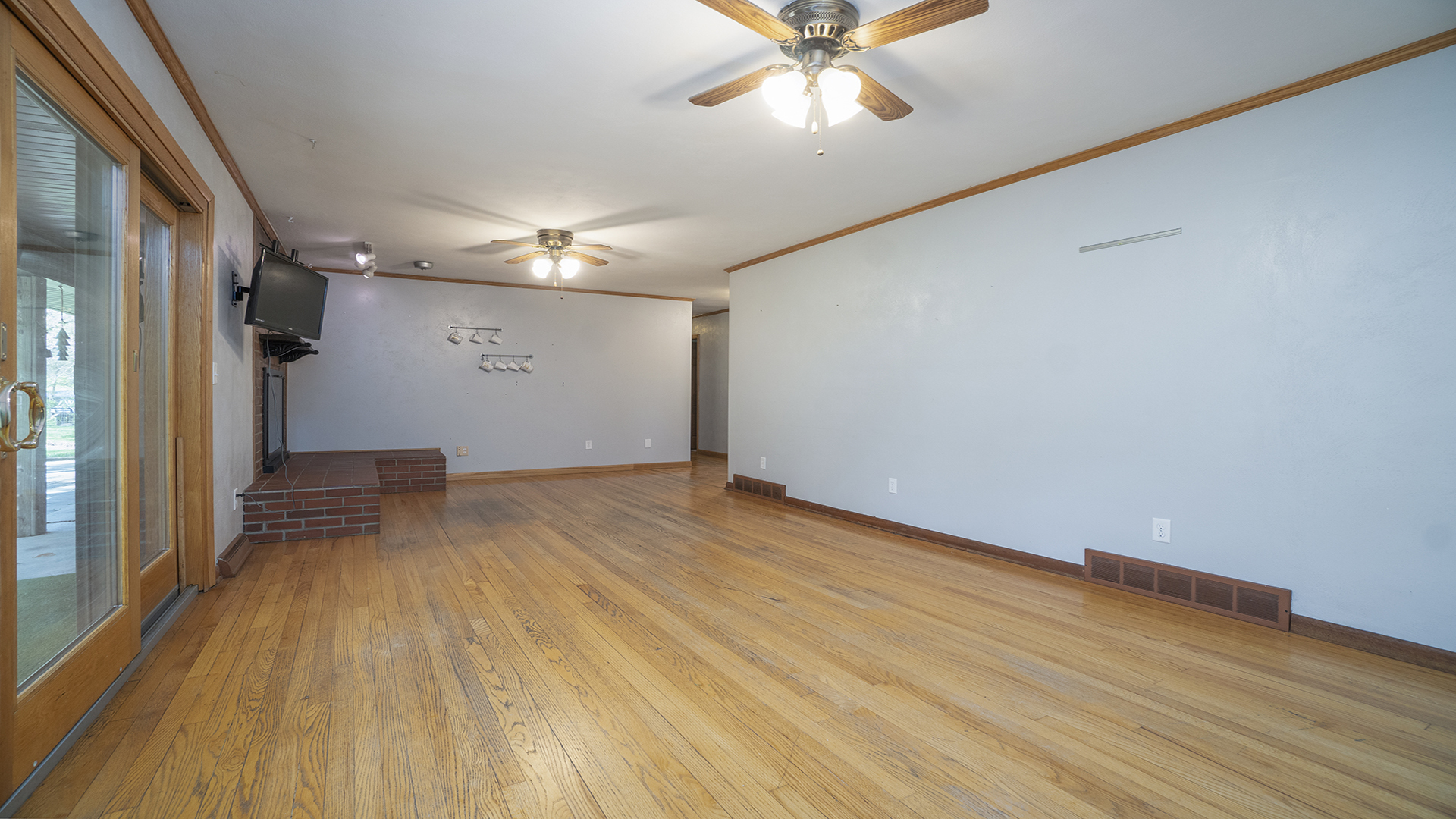 2077 Grand Detour Road Dixon, IL 61021 - Photo 22 of 33 a view of a room with wooden floor and a ceiling fan