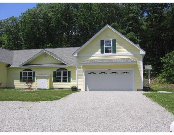 749 Lowell Road, Unit B Groton, MA 01450 - Photo 1 of 16 a front view of a house with a yard and garage