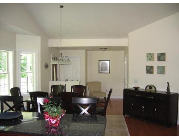 749 Lowell Road, Unit B Groton, MA 01450 - Photo 8 of 16 a living room with furniture a chandelier and a window