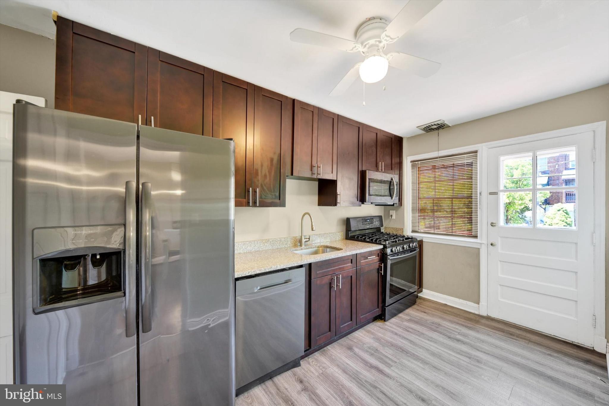 316 Lambeth Road Baltimore, MD 21228 - Photo 11 of 28 a kitchen with a sink stainless steel appliances and cabinets