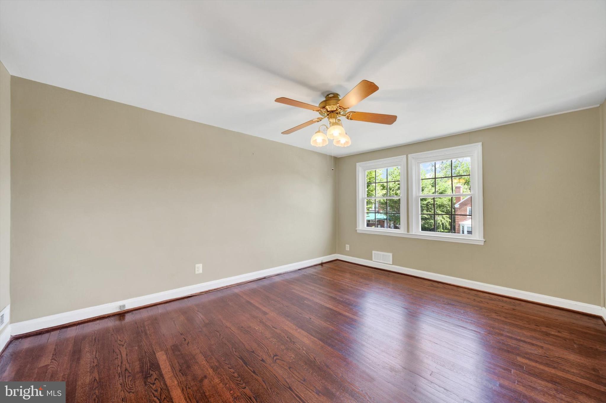 316 Lambeth Road Baltimore, MD 21228 - Photo 15 of 28 an empty room with a window and a fan