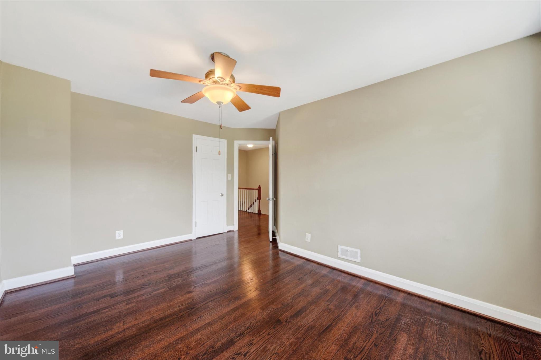 316 Lambeth Road Baltimore, MD 21228 - Photo 16 of 28 a view of an empty room with wooden floor