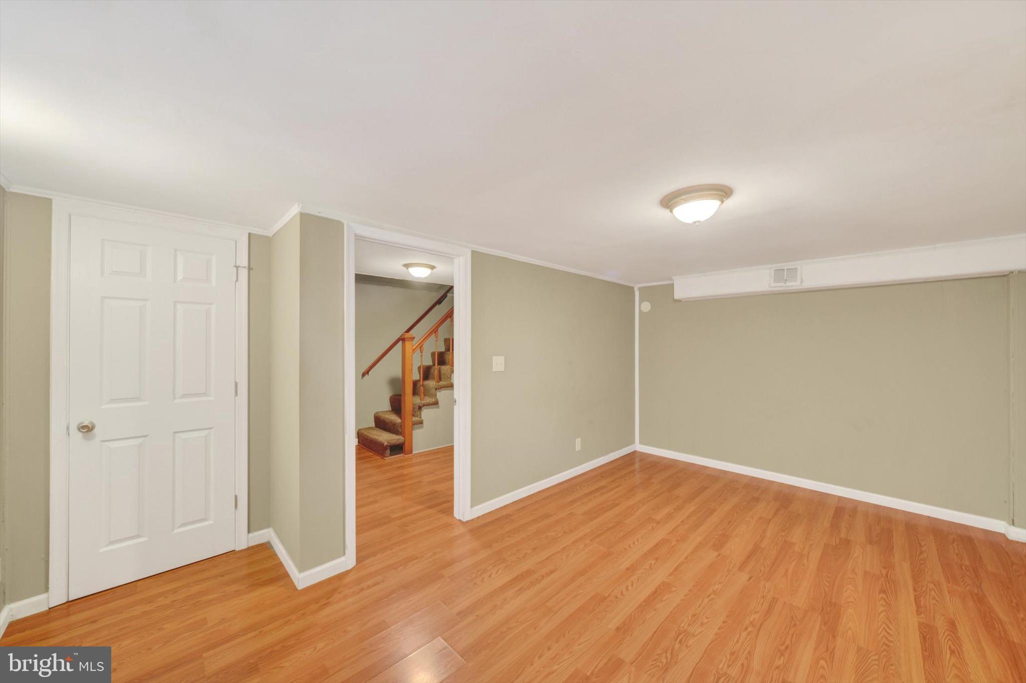 316 Lambeth Road Baltimore, MD 21228 - Photo 21 of 28 a view of empty room with wooden floor and entryway