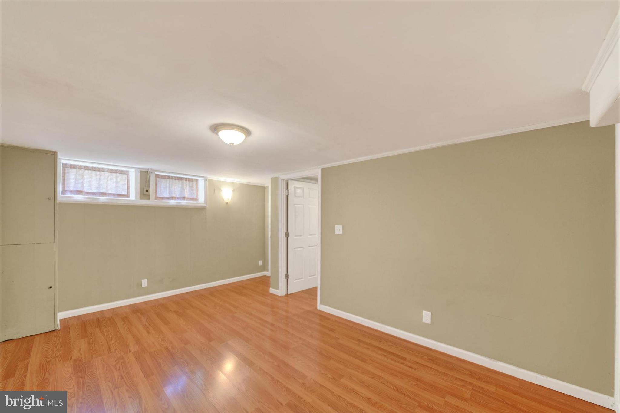 316 Lambeth Road Baltimore, MD 21228 - Photo 22 of 28 a view of an empty room with wooden floor