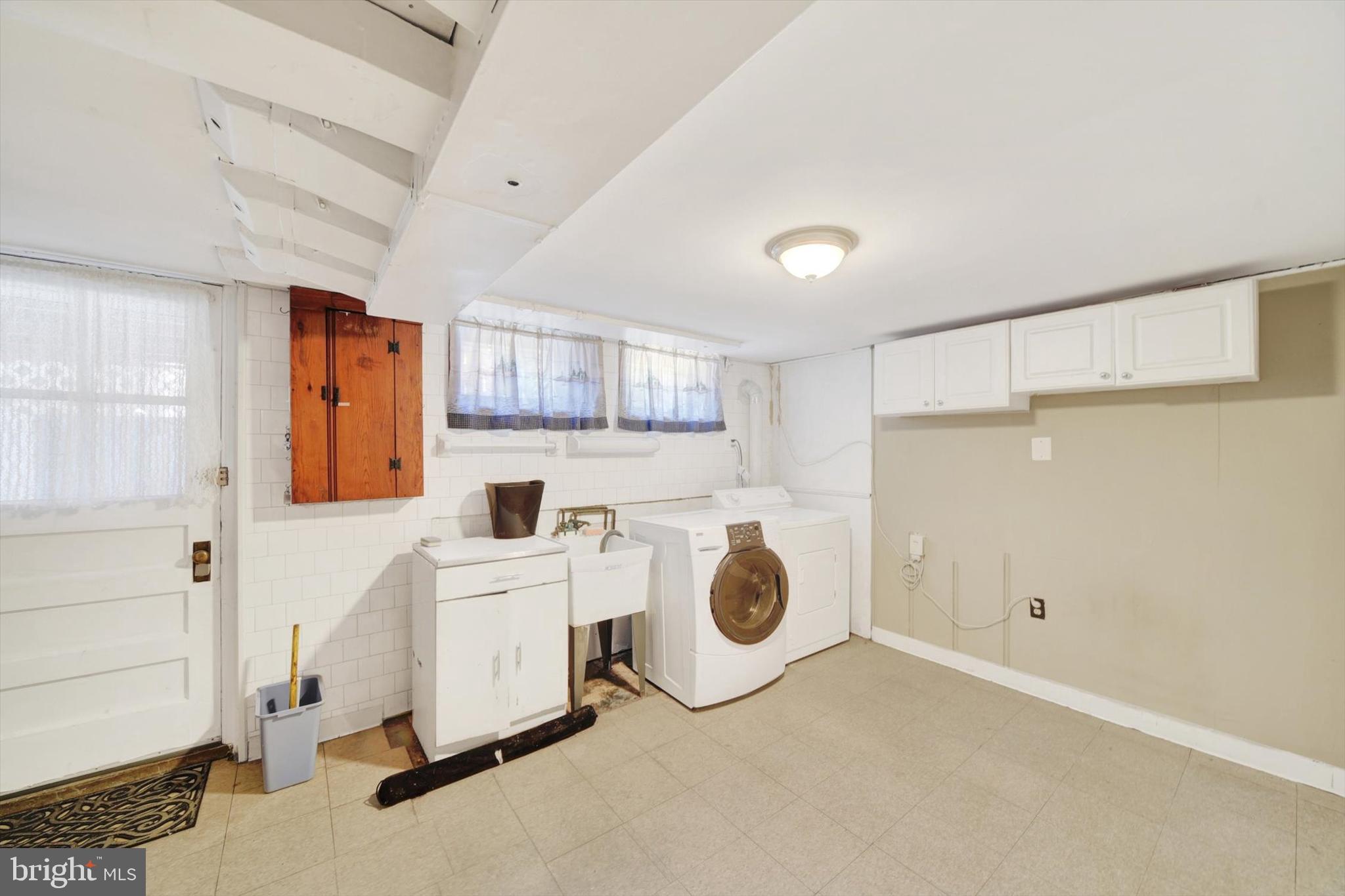 316 Lambeth Road Baltimore, MD 21228 - Photo 23 of 28 a view of a storage & utility room with two washing machine