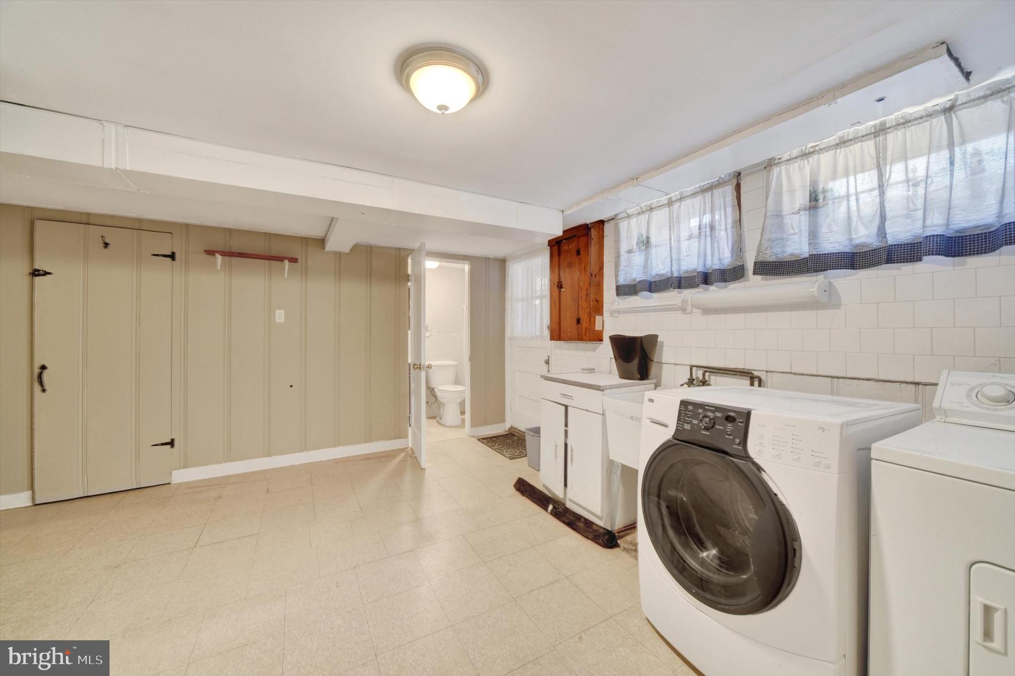 316 Lambeth Road Baltimore, MD 21228 - Photo 24 of 28 a view of a kitchen with a sink and a washer dryer