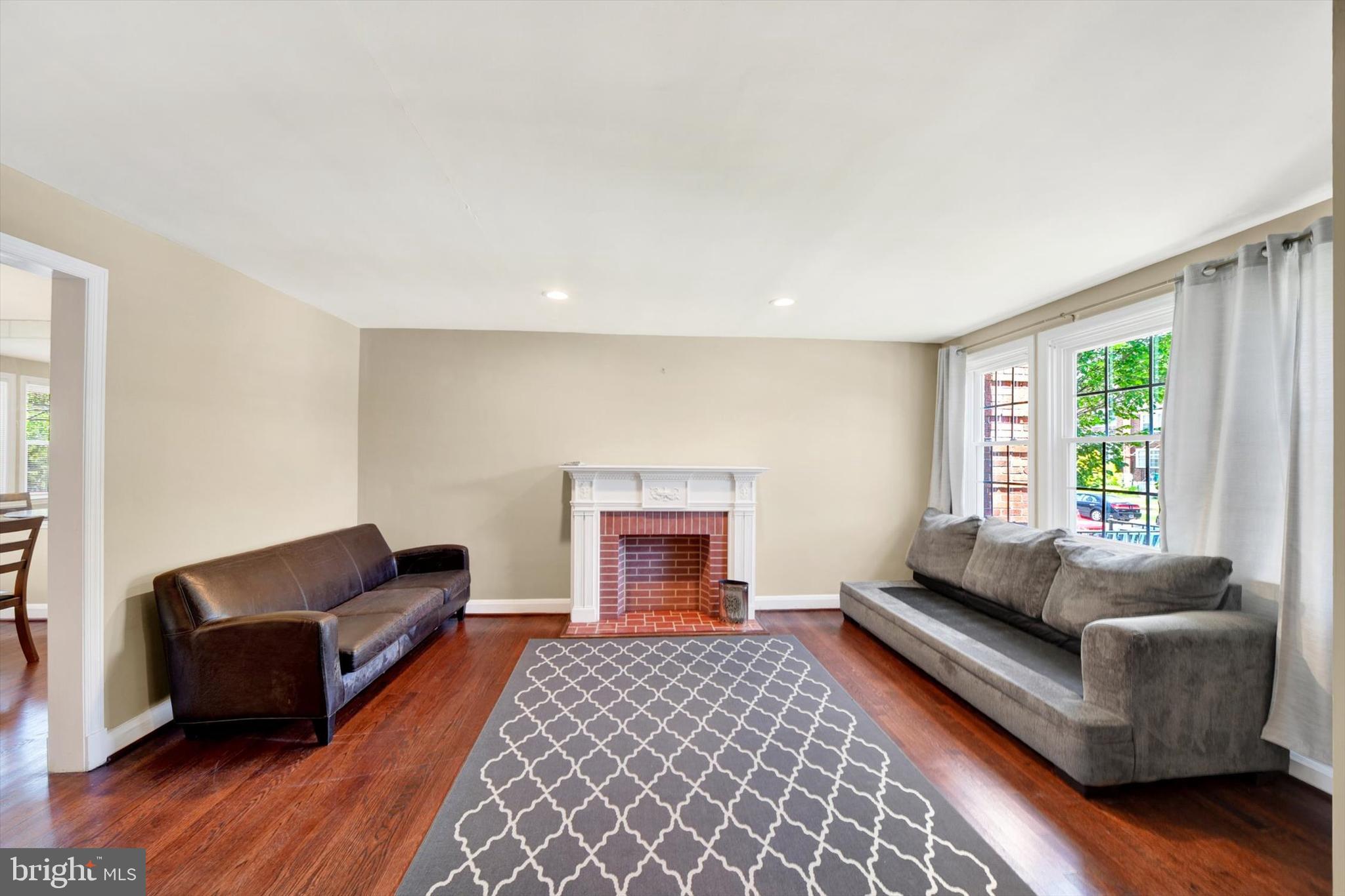 316 Lambeth Road Baltimore, MD 21228 - Photo 6 of 28 a living room with furniture and a fireplace