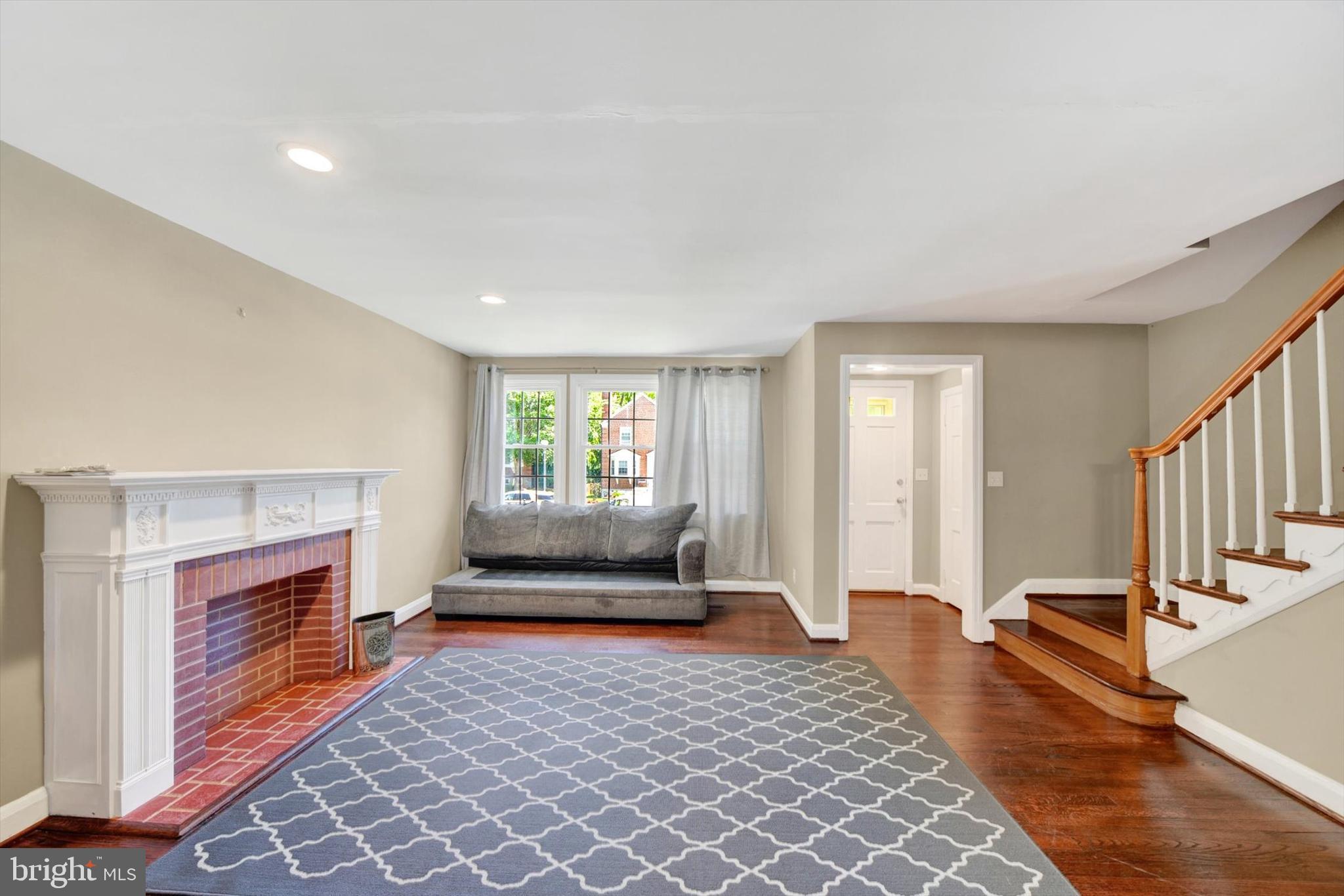 316 Lambeth Road Baltimore, MD 21228 - Photo 7 of 28 a living room with furniture and a fireplace