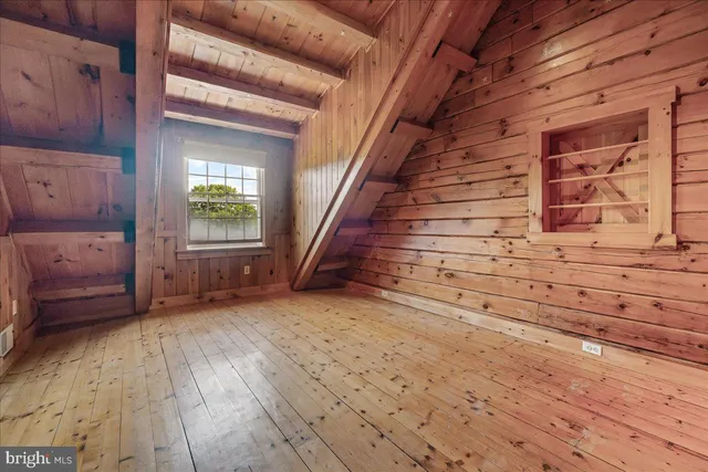 a view of empty room with wooden floor and fireplace