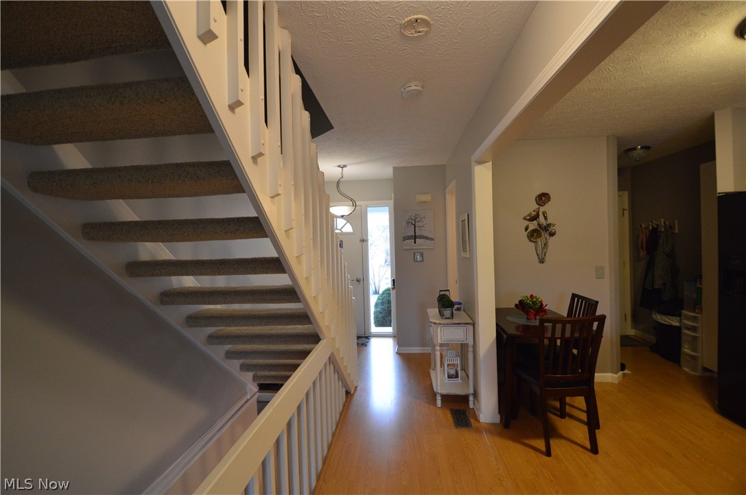 View from the living room into the foyer and kitchen