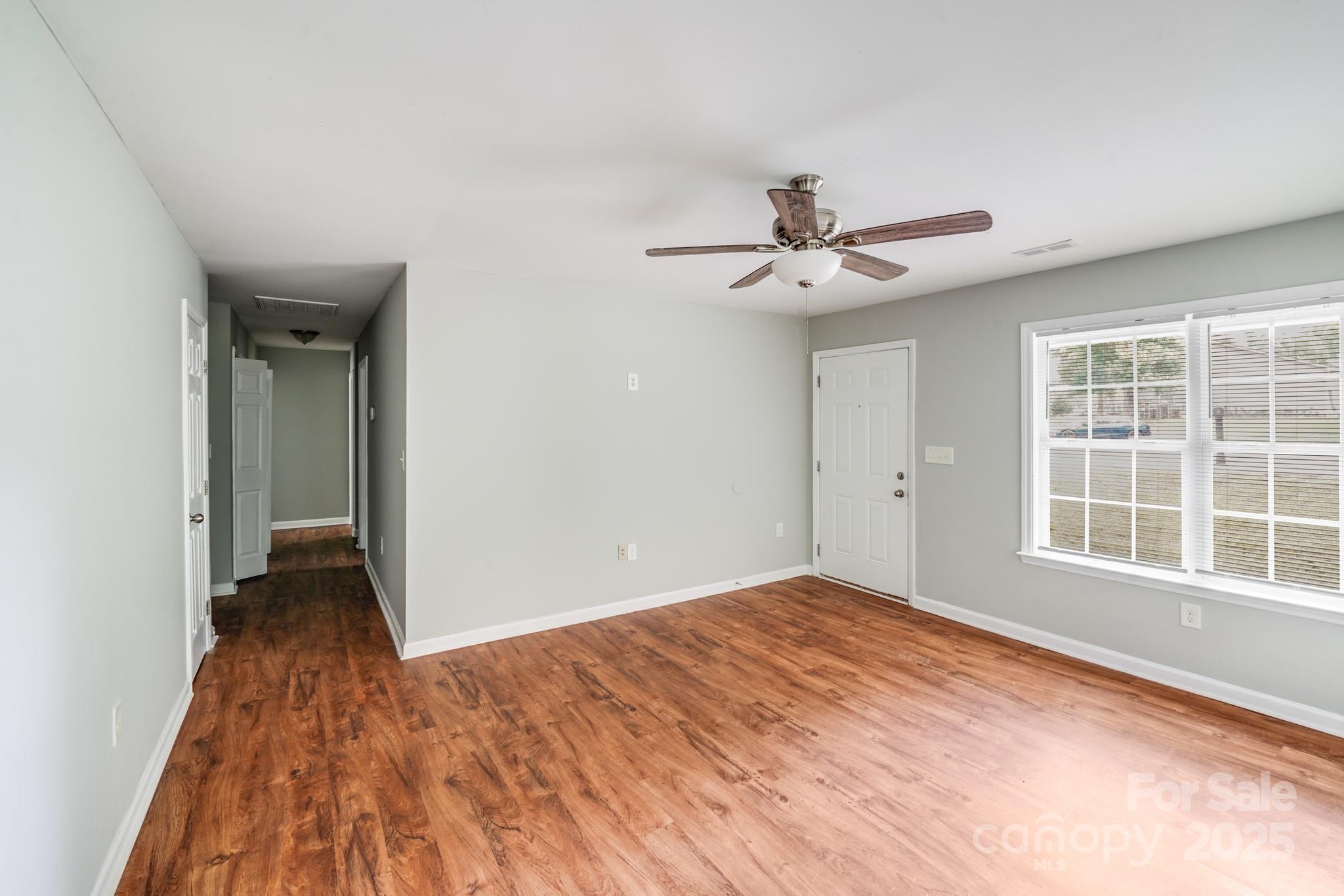 3134 Rainbow Ridge Drive Matthews, NC 28105 - Photo 3 of 20 a view of an empty room with a window and wooden floor