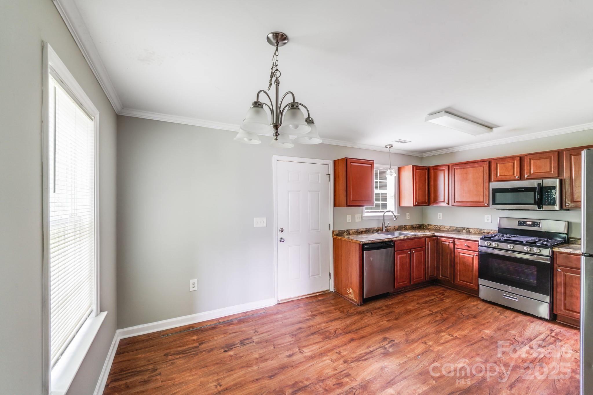 3134 Rainbow Ridge Drive Matthews, NC 28105 - Photo 4 of 20 a kitchen with stainless steel appliances granite countertop a stove and a refrigerator