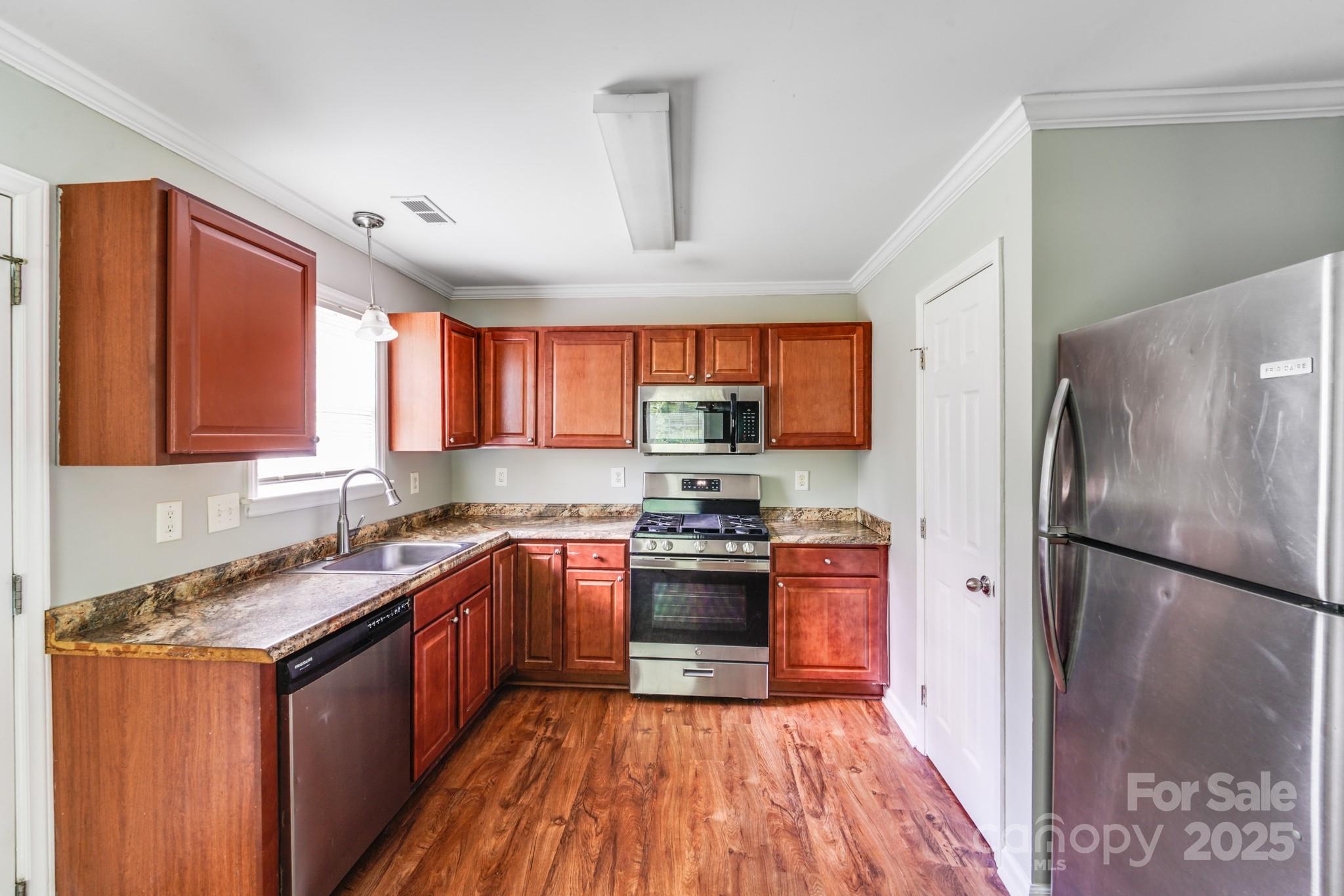 3134 Rainbow Ridge Drive Matthews, NC 28105 - Photo 5 of 20 a kitchen with stainless steel appliances granite countertop a refrigerator a sink dishwasher a stove top oven a refrigerator and cabinets