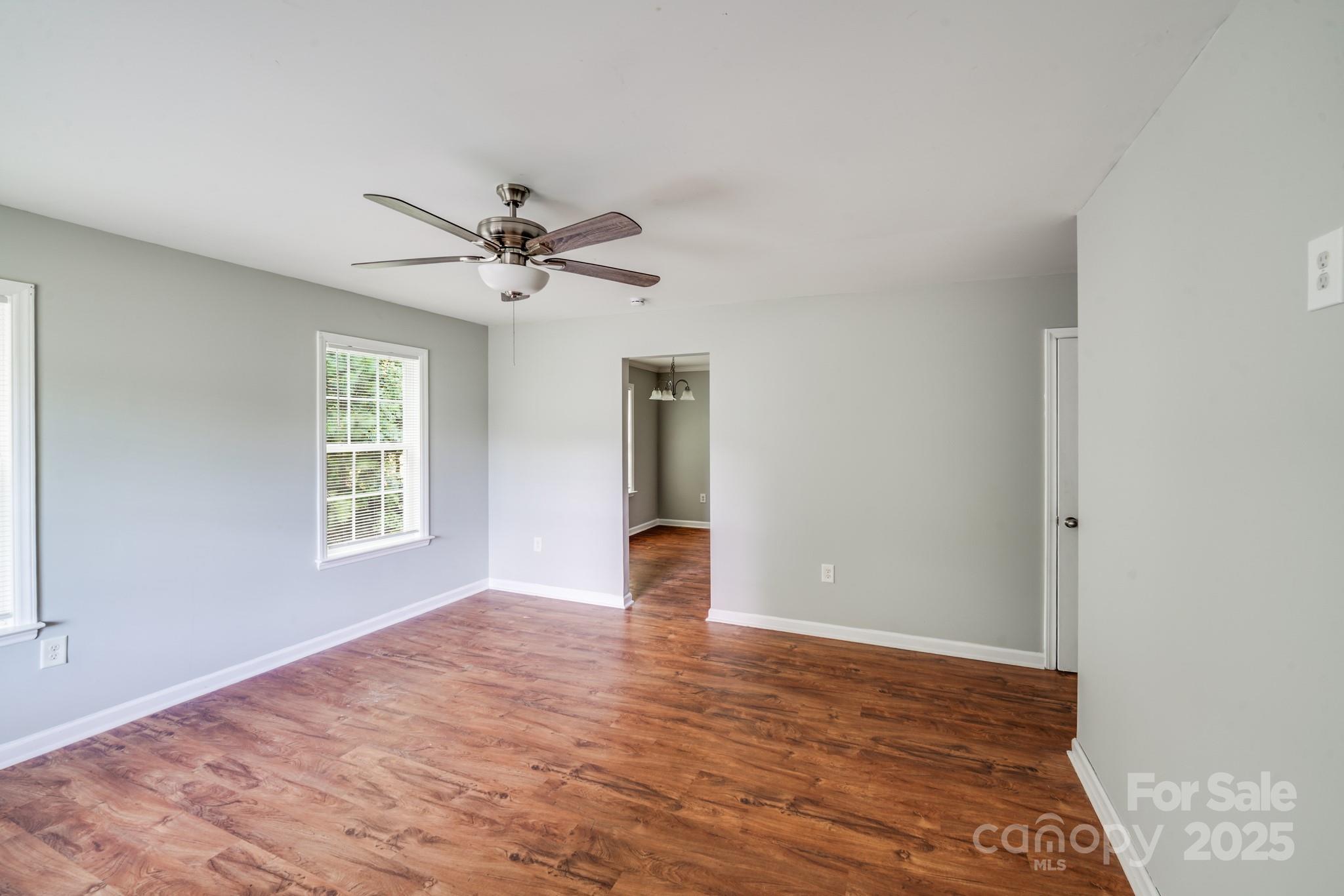 3134 Rainbow Ridge Drive Matthews, NC 28105 - Photo 7 of 20 a view of an empty room with window and wooden floor