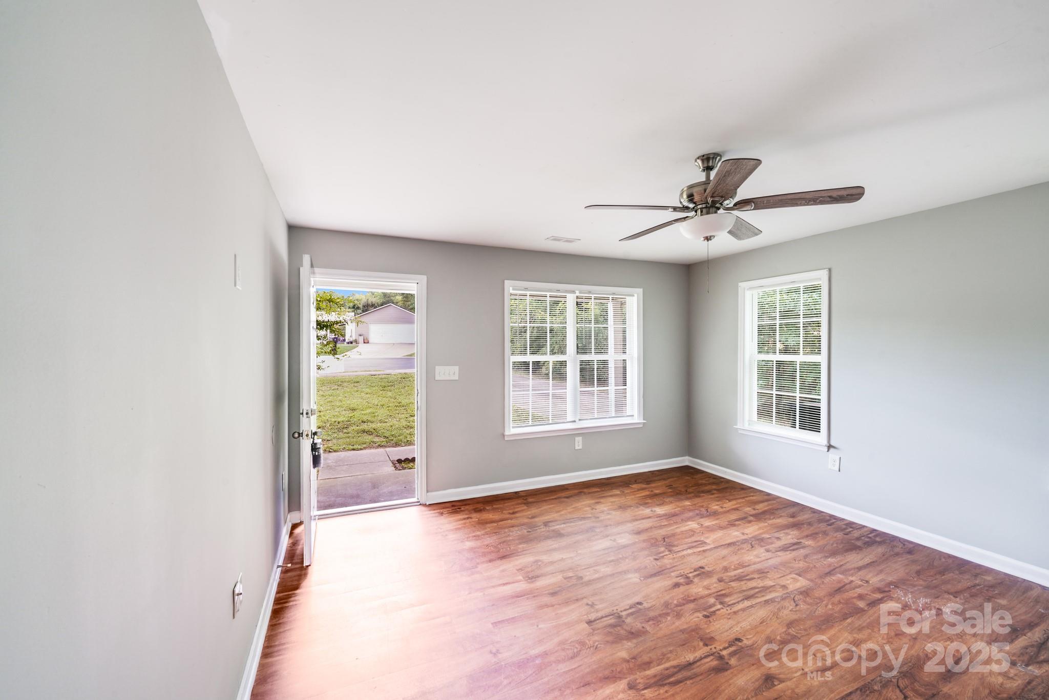 3134 Rainbow Ridge Drive Matthews, NC 28105 - Photo 8 of 20 a view of a livingroom with a ceiling fan and windows